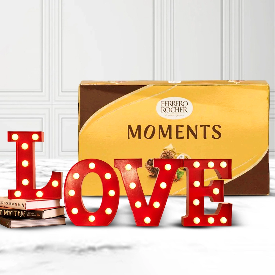Lovely LOVE LED lamp next to a box of Ferrero Rocher chocolates, creating a romantic gift for Valentine's Day.