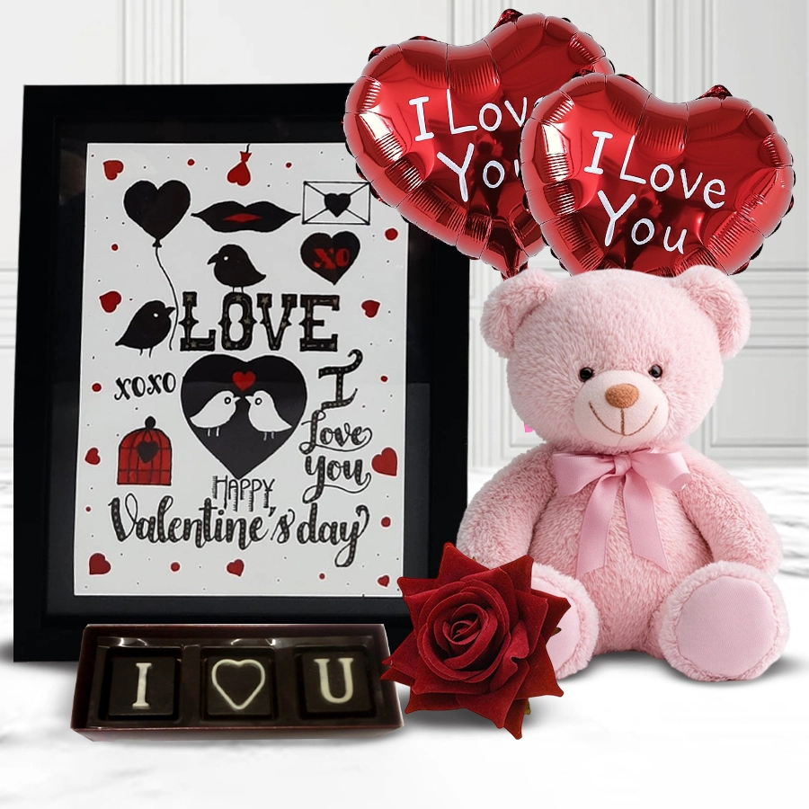 Delightful Valentine's gift pack featuring a plush teddy bear, handmade chocolates, Mylar balloons, a red velvet rose, and a photo frame.