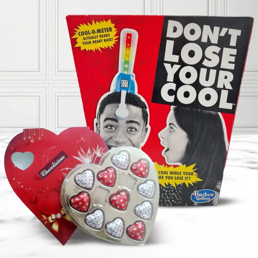 Couple playing a Naughty Adult Board Game with heart-shaped chocolates on a romantic Valentine's Day setting.