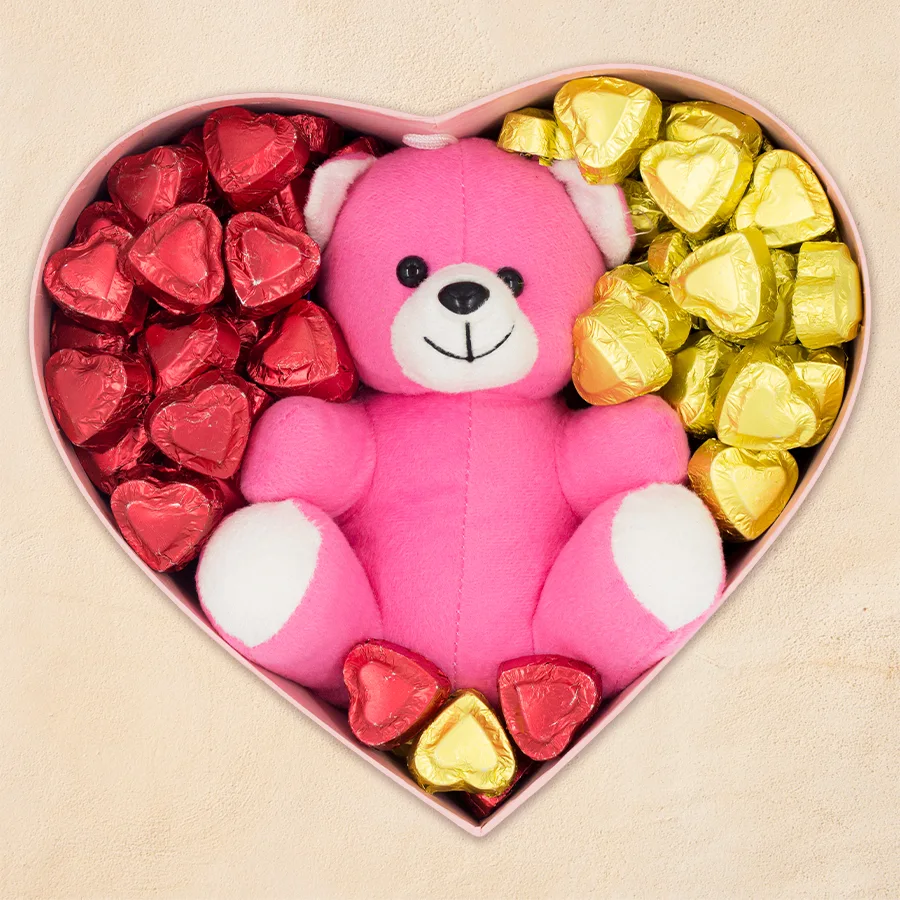 Exclusive heart-shaped handmade chocolates in a heart box next to a cute teddy bear.