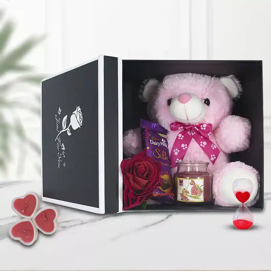 Beautiful Love Delight Gift Box with teddy bear, chocolate bar, aroma candle, Love Timer, and red velvet rose in a decorative box.