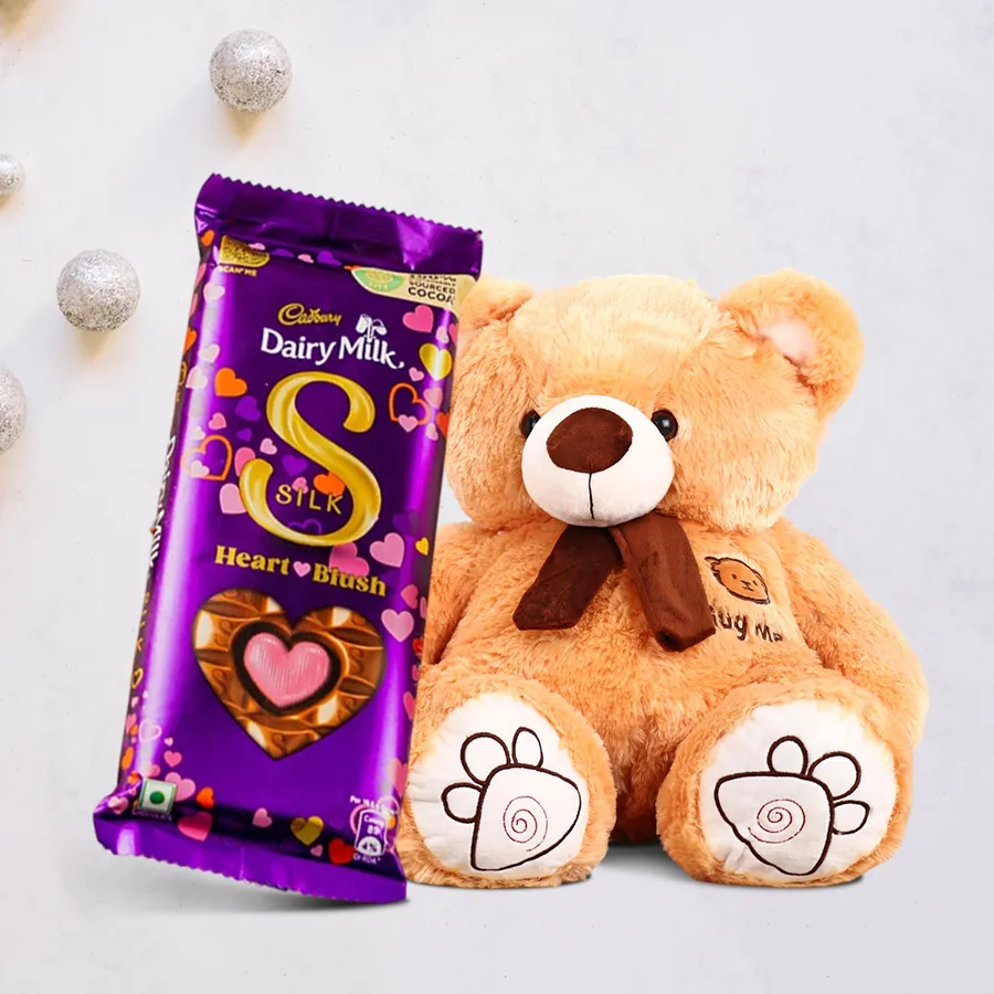 Exciting Teddy with a 160g Cadbury Silk Heart chocolate set, featuring a 40 cm cuddly teddy bear and heart-shaped chocolate packaging.