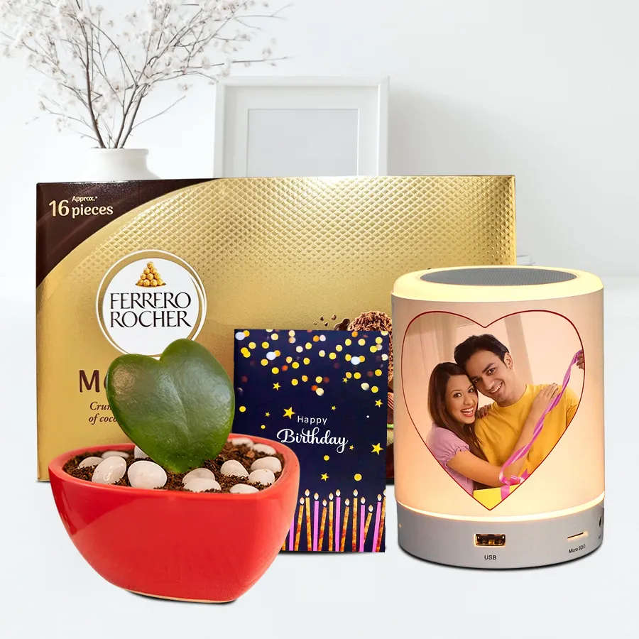 Personalized speaker, Ferrero Rocher chocolates, sweetheart plant, and birthday card arranged in a gift hamper