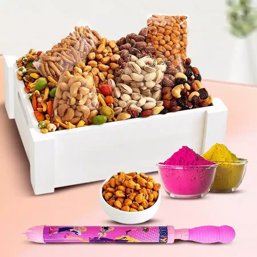 Mixed dry fruits gift hamper featuring roasted cashews, salted almonds, pistachios, dried figs, toffees, and festive essentials like a pichkari and colorful herbal gulal, ideal for Holi celebrations.