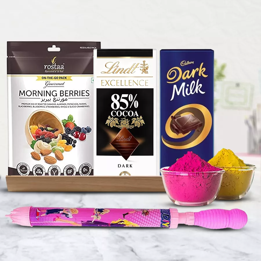 Scrumptious Chocolates Gift Hamper for Holi featuring Lindt 85% Dark chocolates, Cadbury Dark Milk, Roastta Morning Berries, a Pichkari, herbal Gulal, all arranged in a charming wooden tray.