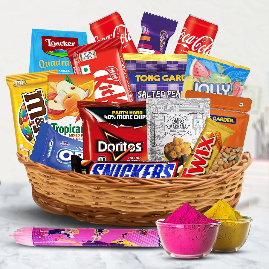 Sweet n Savory Gift Hamper for Holi featuring snacks, chocolates, drinks, and a pichkari in a cane basket.