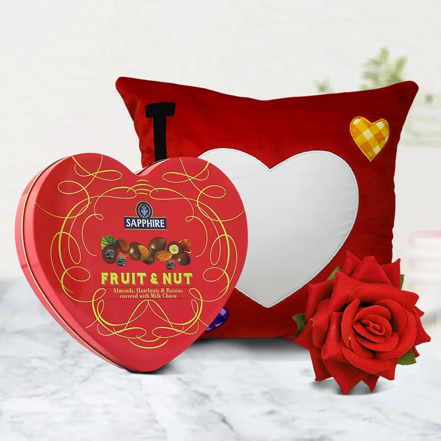 Personalized ILU heart cushion with Sapphire Heart chocolate box and velvet rose on a decorative background.