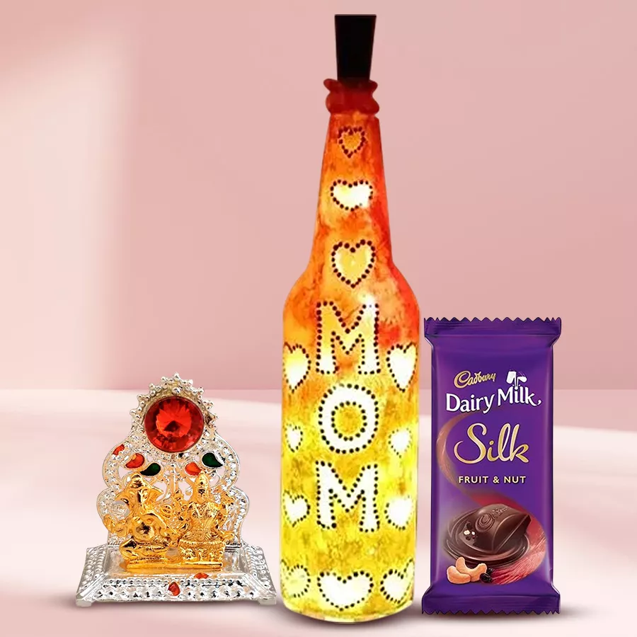 Handcrafted bottle lamp with Ganesh Laxmi Mandap beside Cadbury Dairy Milk Silk Fruit n Nut showcasing a heartfelt gift for Mom.
