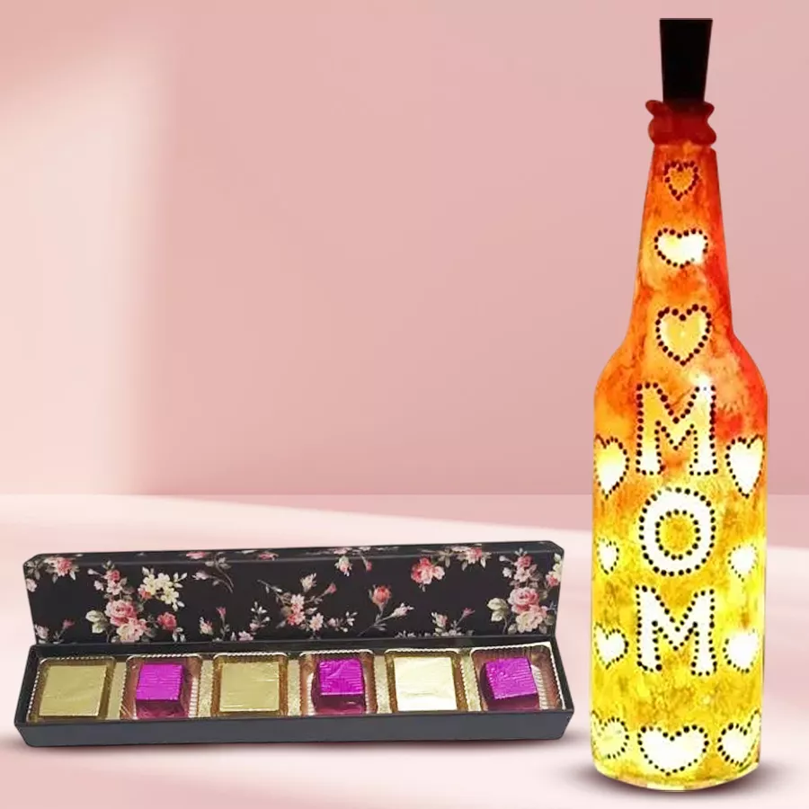 Handcrafted bottle lamp with warm LED glow alongside a box of handmade chocolates filled with dried mango and strawberry, perfect gift for Mom
