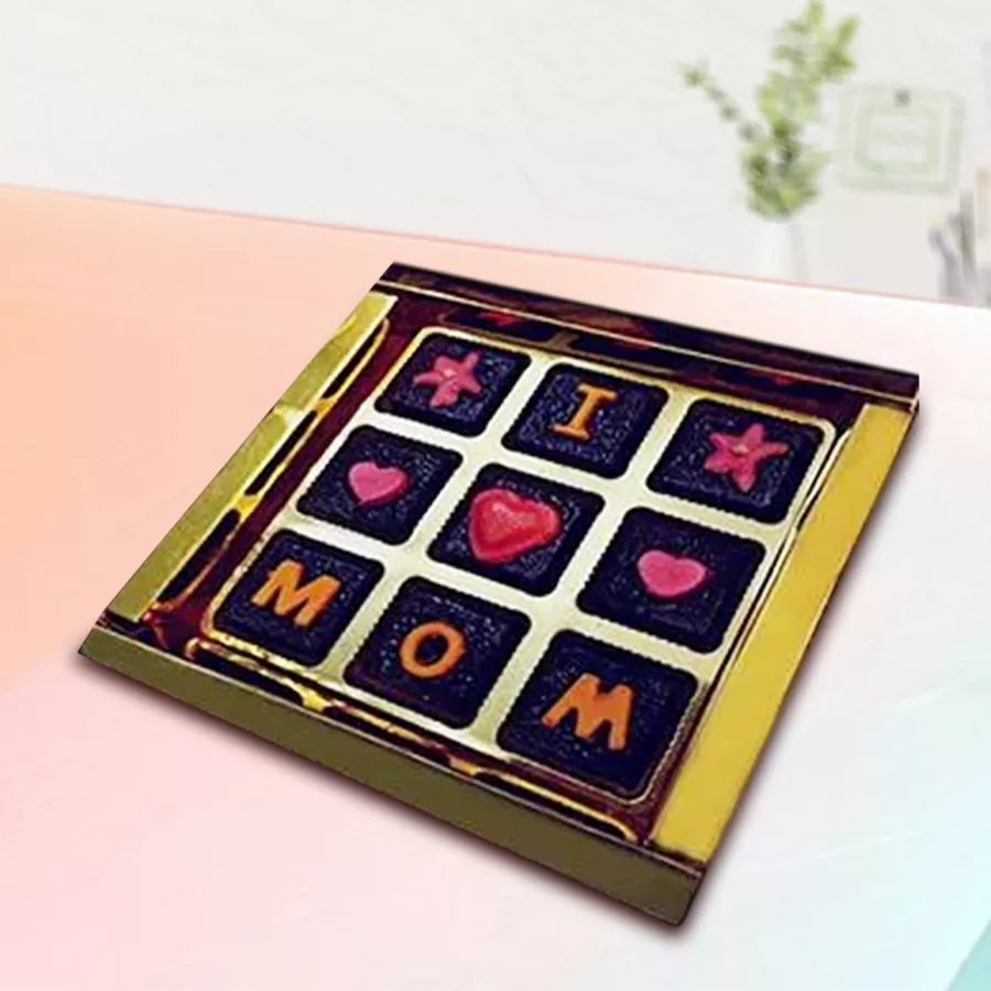 Handmade chocolates arranged in a heart shape with a label that reads "I Love Mom"