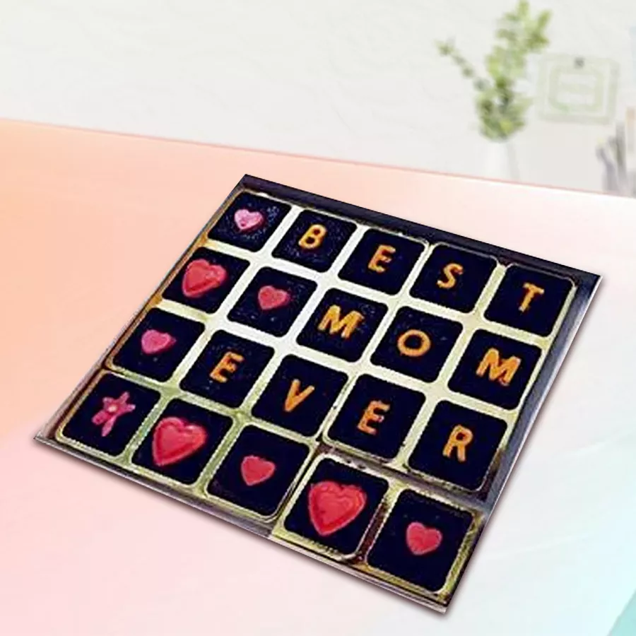 Assorted handmade chocolates in a beautifully packaged box labeled "Best Mom Ever"