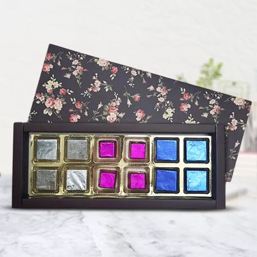 Chocolate gift box containing handmade chocolates filled with strawberry, kiwi, and cranberry flavors
