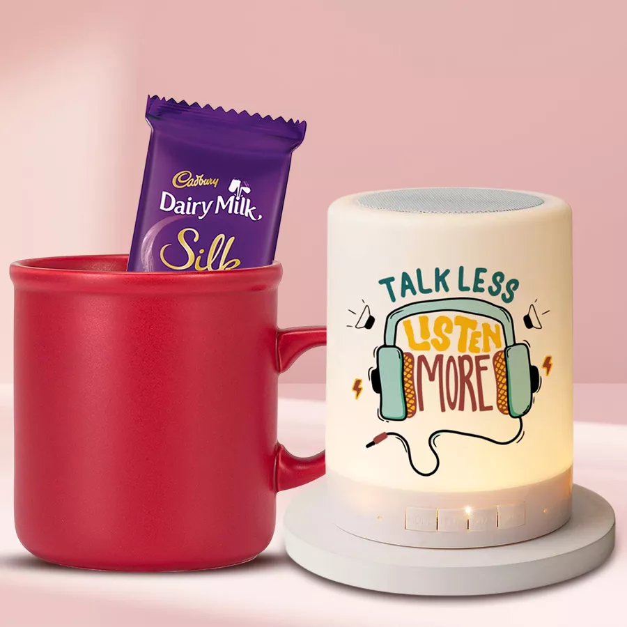 Trendy Sister Coffee Mug with personalized design, Bluetooth speaker, and Cadbury Dairy Milk Silk chocolate bar arranged beautifully as a Raksha Bandhan gift set.