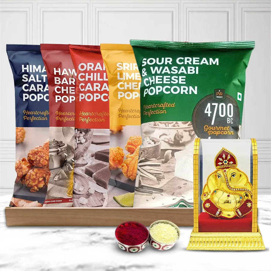 Classy Gift Hamper featuring flavored popcorn, Vighnesh idol, wooden tray, and Roli Chawal Tilak for Bhai Dooj celebration