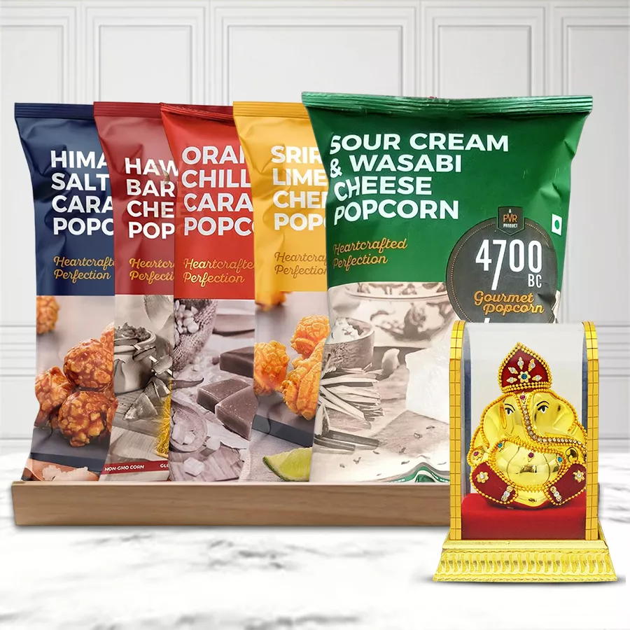 Magical Gift Hamper featuring assorted Himalayan popcorn flavors, a Vighnesh Idol, and a reusable wooden tray