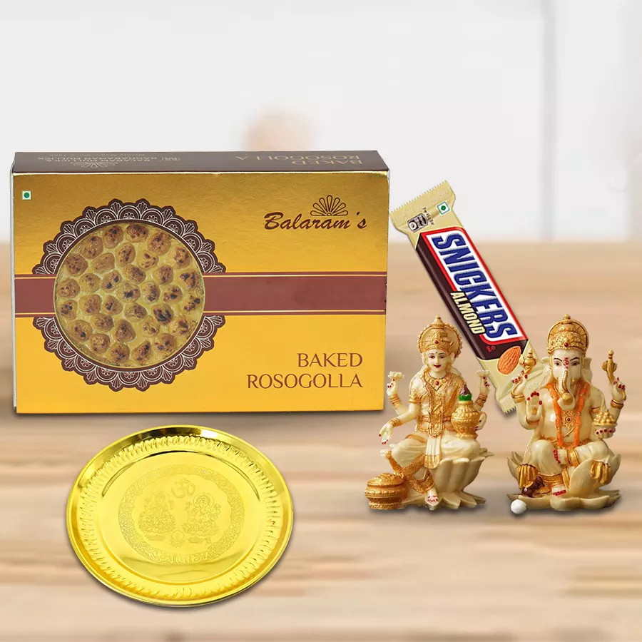 Elegant thali gift combo featuring a gold-plated German Silver Thali, Balaram Mullick baked rasgullas, Snickers Almond chocolate, and a Laxmi Ganesh idol, beautifully arranged for Diwali celebration.