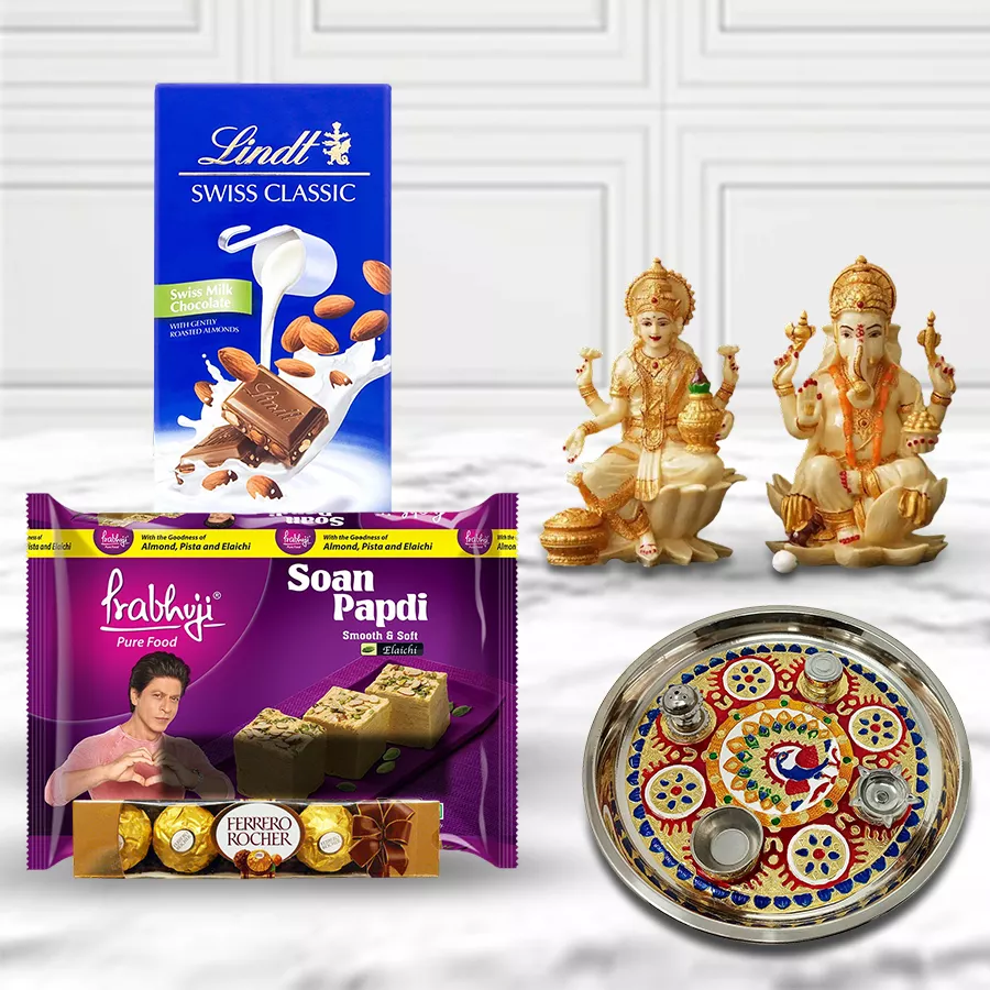 Gorgeous Pooja Thali with Haldiram Soan Papdi, Lindt Swiss Milk Chocolates, Ferrero Rocher, and Laxmi Ganesh idol, beautifully arranged for Diwali celebrations