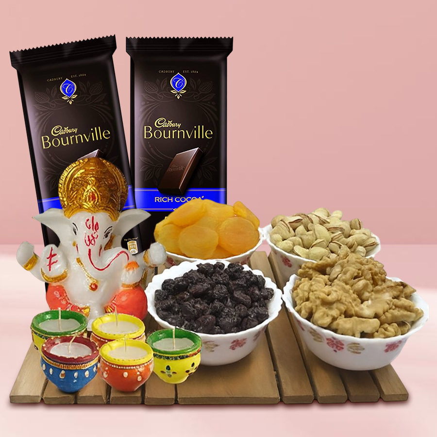 Ecstatic Cadbury Chocolates and Dry Fruits hamper featuring premium pistachios, walnuts, dried apricots, cranberries, two Cadbury Bournville chocolates, a Vighnesh Ganesh idol, and five matka wax diyas on a festive background.