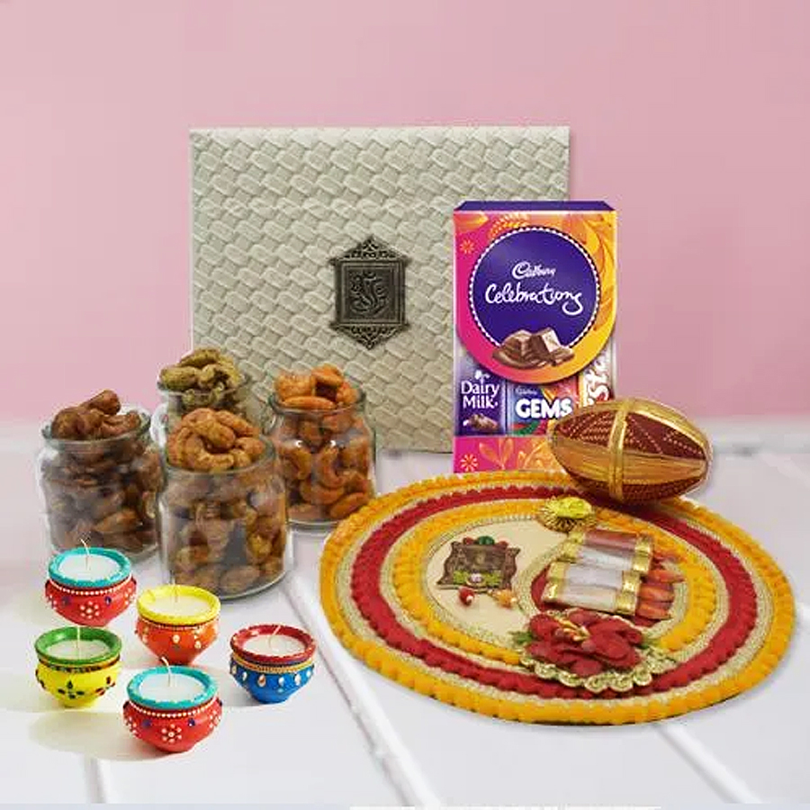 Alluring Diwali gift thali featuring flavored cashew chocolates, decorative diya, and a Shree pooja thali in a reusable box.