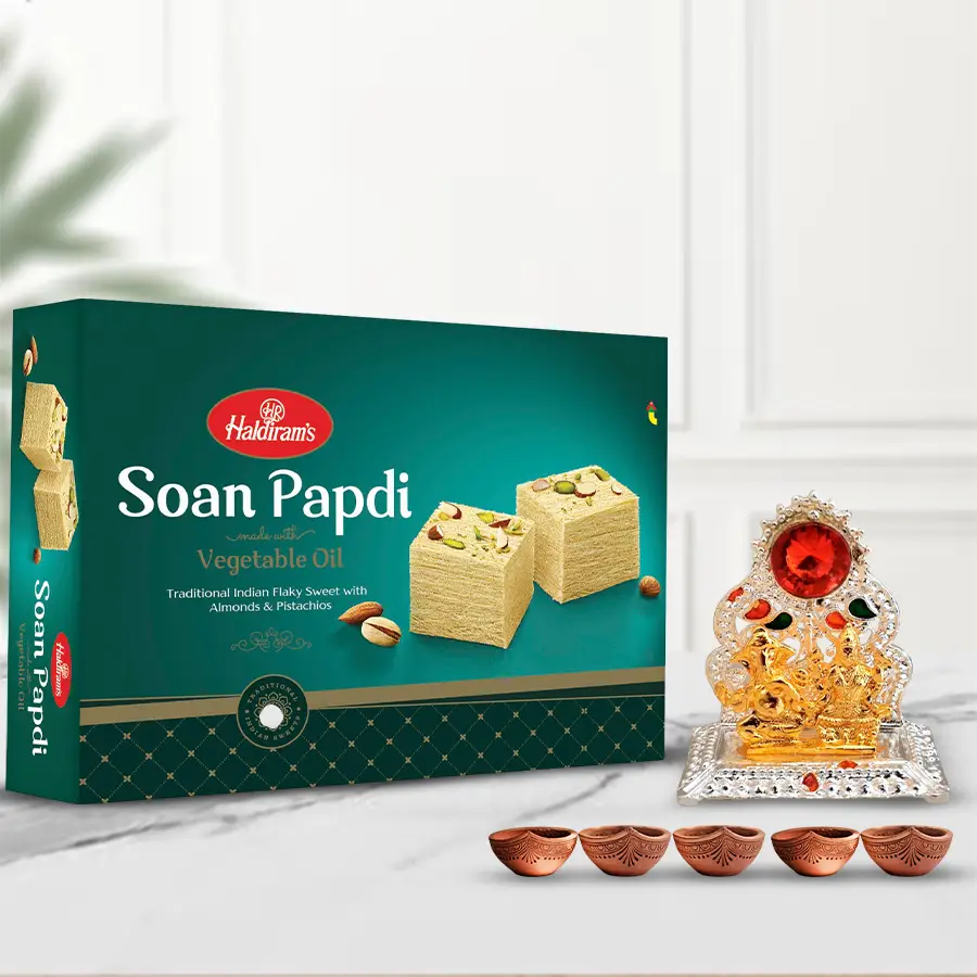 Pious Lakshmi Ganesh Mandap with Haldiram Soan Papdi and five decorative diyas