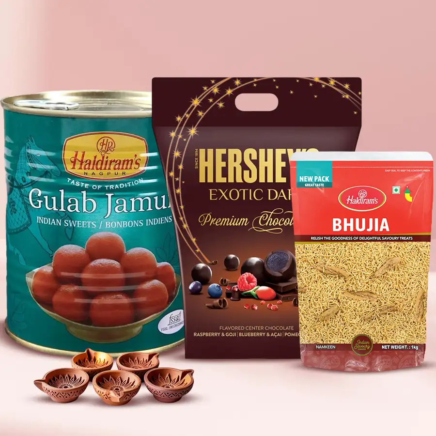 Zesty Hershey's dark chocolates, Haldiram sweets including Gulab Jamun and crispy Bhujiya, and five Kuber Mud Diyas in a festive gift pack for Diwali celebrations.