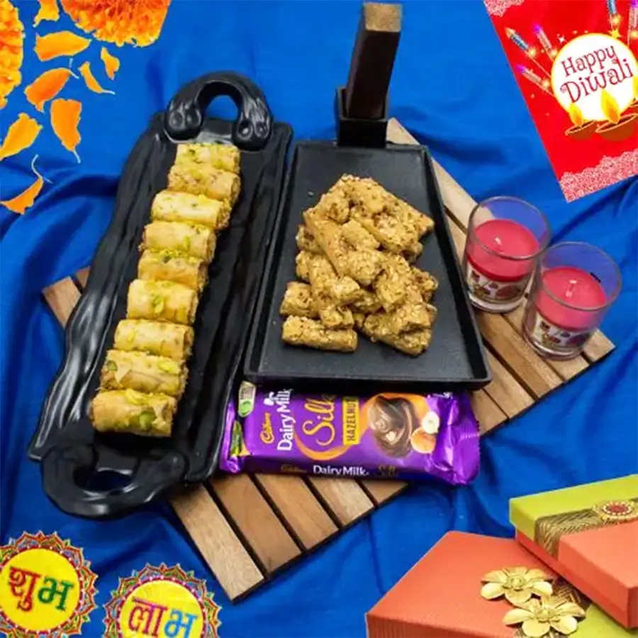 Perfect selection of tart baklava, almond sticks, Cadbury hazelnut chocolate bar, and two shot glass candles for Diwali celebration.