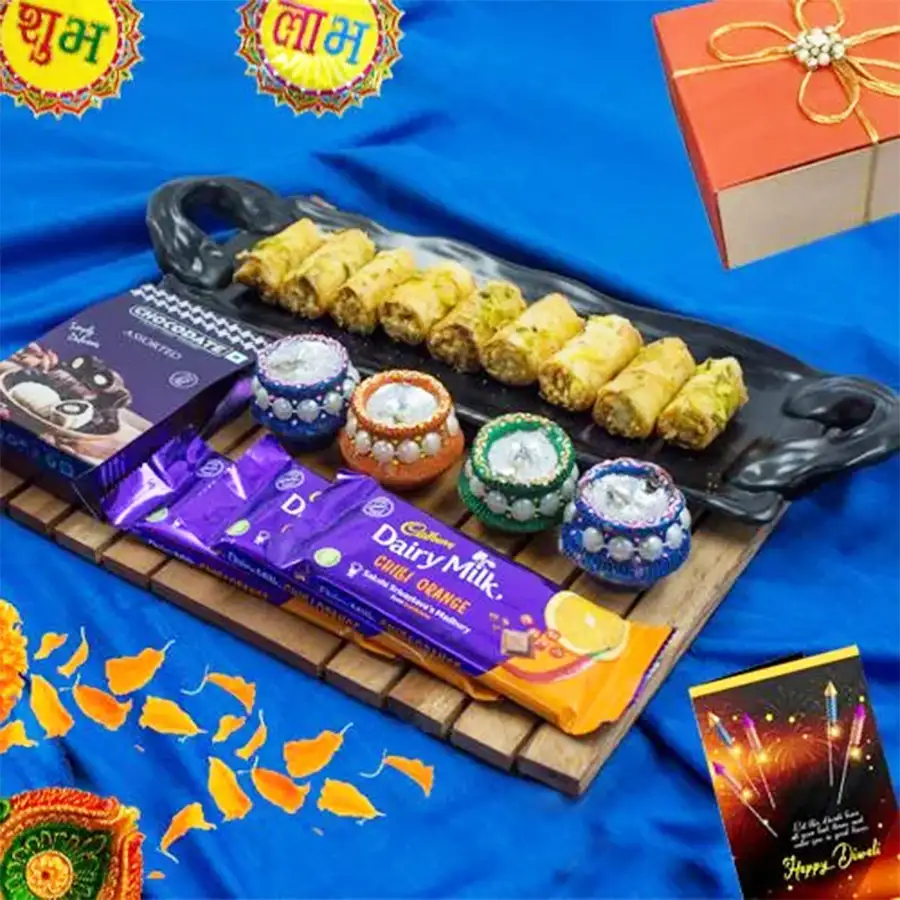 Finest selection of Roll Baklava, Cadbury Chocolates, and colorful Wax Diyas in a festive gift box for Diwali celebrations