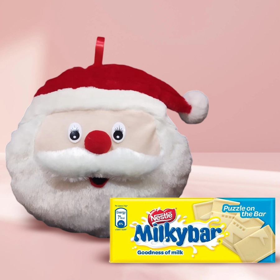 Santa Emoji Cushion alongside a Milky Bar, both presented as a fun and cozy Christmas gift for kids.