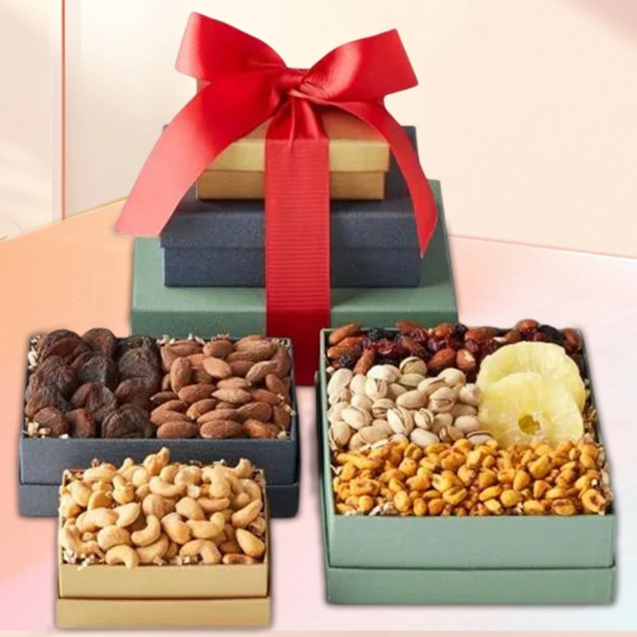 Three-tiered gift tower filled with exotic dried fruits and nuts, including salted pistachios, dried kiwi, salted peanuts, mixed nuts, salted almonds, turkel apricots, and salted cashews, elegantly tied with a festive ribbon.