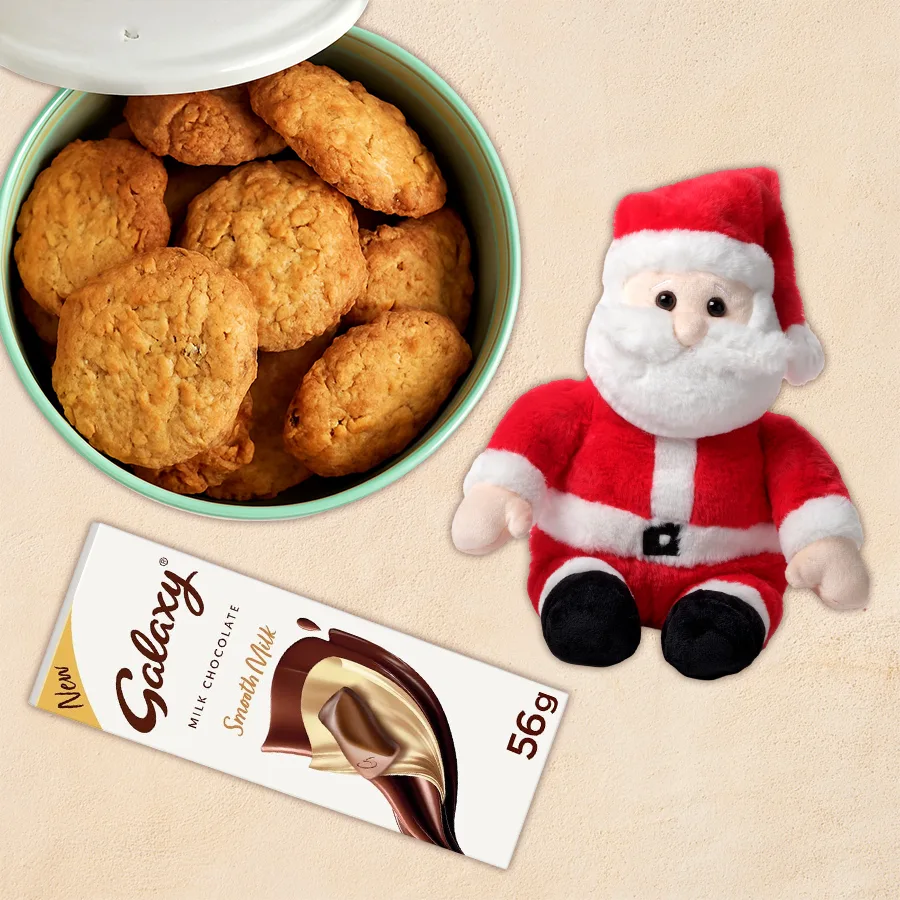 A festive bundle featuring two Apricot Supreme Cookies, a Galaxy Milk Chocolate Bar, and a cute Sitting Santa Claus soft toy, arranged together for holiday gifting.