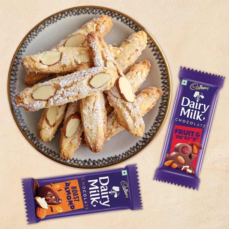 Santa's Cadbury Silky Gift box featuring Dairy Milk Silk Fruit and Nut, Silk Roast Almond bars, and Almond Fingers cookies for Christmas.