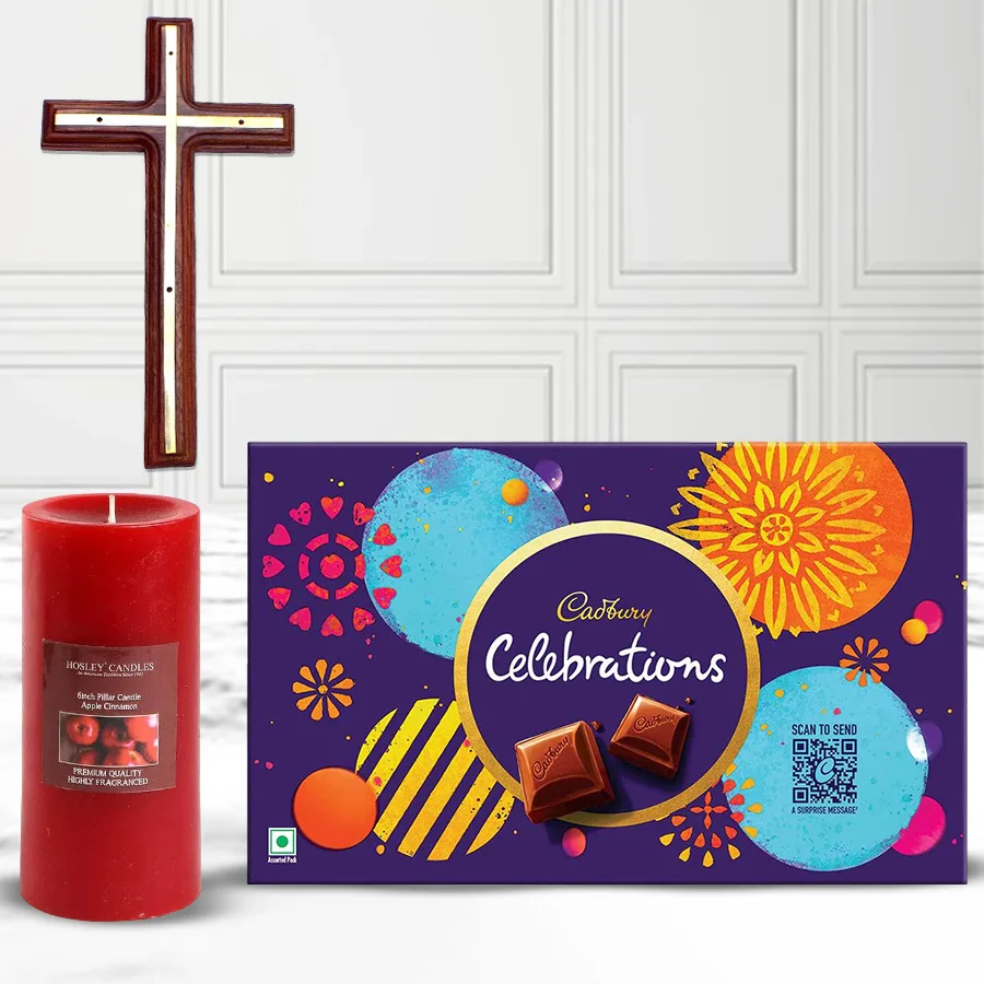Christ Cross wall hanging, apple cinnamon-scented pillar candle, and Cadbury assorted chocolates in a gift combo arrangement.