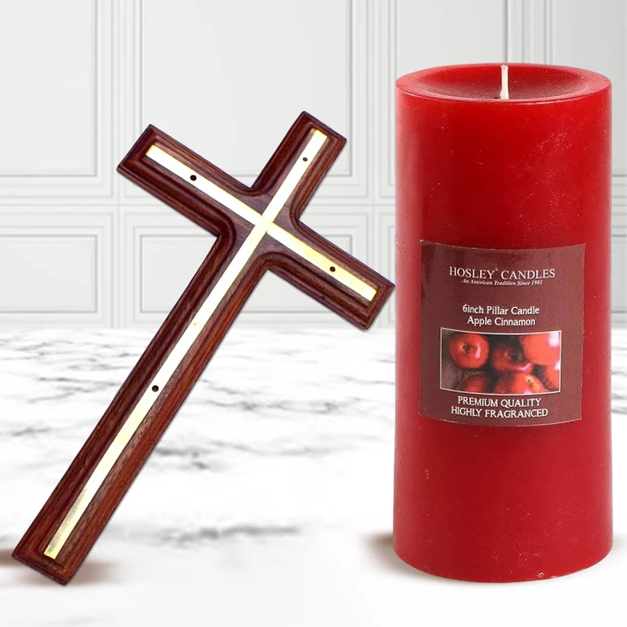 Holy Cross and Apple Cinnamon Pillar Candle set displayed together, showcasing the wooden cross and the candle in a festive setting.
