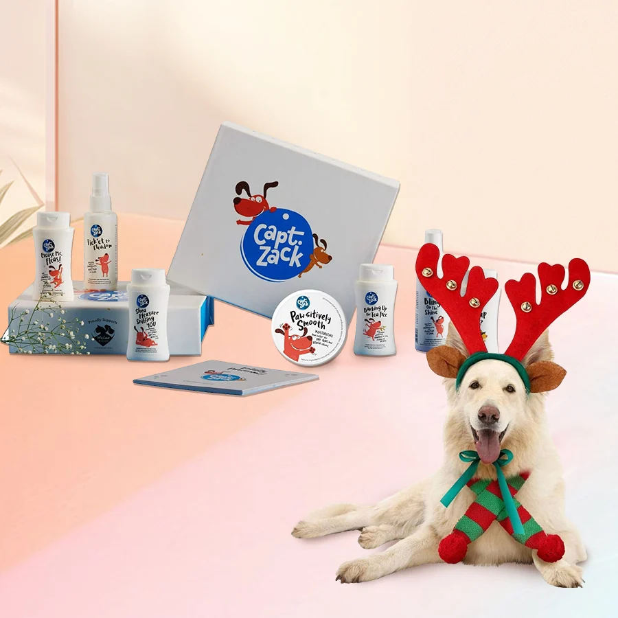 Miniature gift box with a headband featuring reindeer antlers and bells next to pet grooming products.