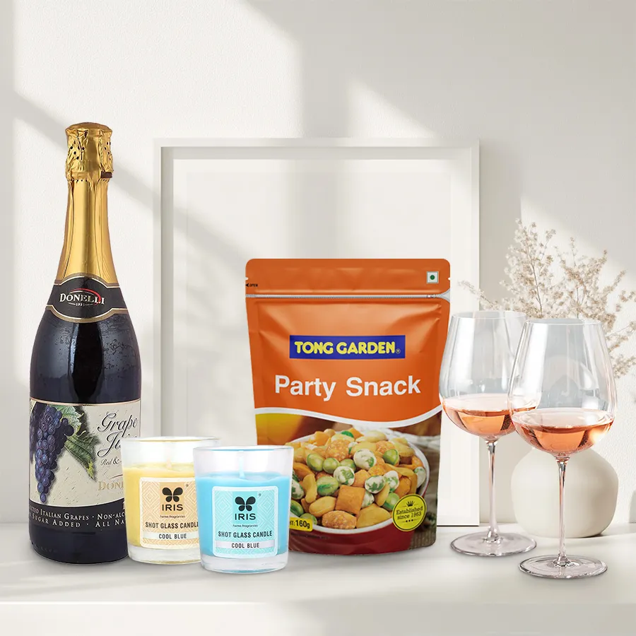 Xmas evening party combo with sparkling grape juice, snacks, two wine glasses, and aroma candles