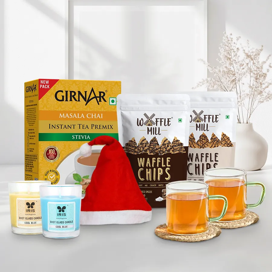 Magnificent Xmas Surprise bundle featuring Masala Chai, Waffle Chips in Milk Choco Drizzle and Dark Choco with Sea Salt, Borosils Tea & Coffee Glass Mug Set, and a festive Christmas cap.
