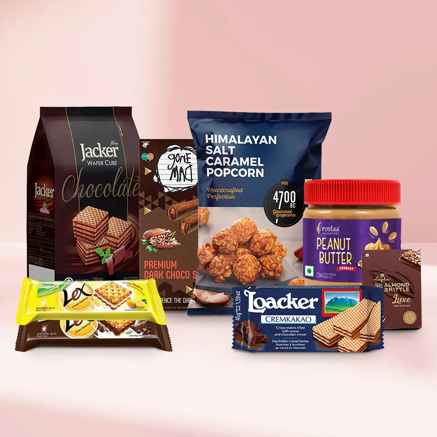 Gourmet gift hamper filled with Himalayan Salt Popcorn, chocolate and lemon cream biscuits, wafer cubes, peanut butter, almond brittle, dark chocolate sticks, and cream wafers, arranged beautifully for Christmas.