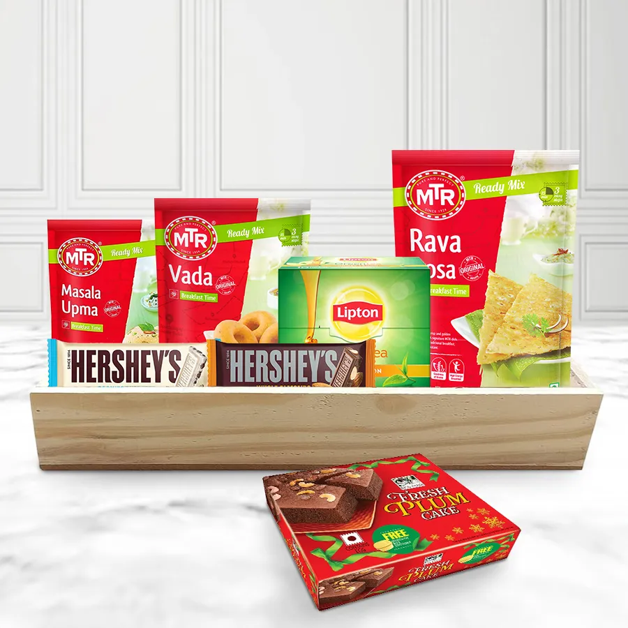 Impressive MTR Mix Breakfast Hamper for Christmas featuring MTR Masala Upma, Rava Dosa, Vada mixes, Lipton Honey Lemon Green Tea, Hershey’s Cookies n Crème chocolate, Whole Almond chocolate, Biskfarm Plum Cake, and a wooden tray.