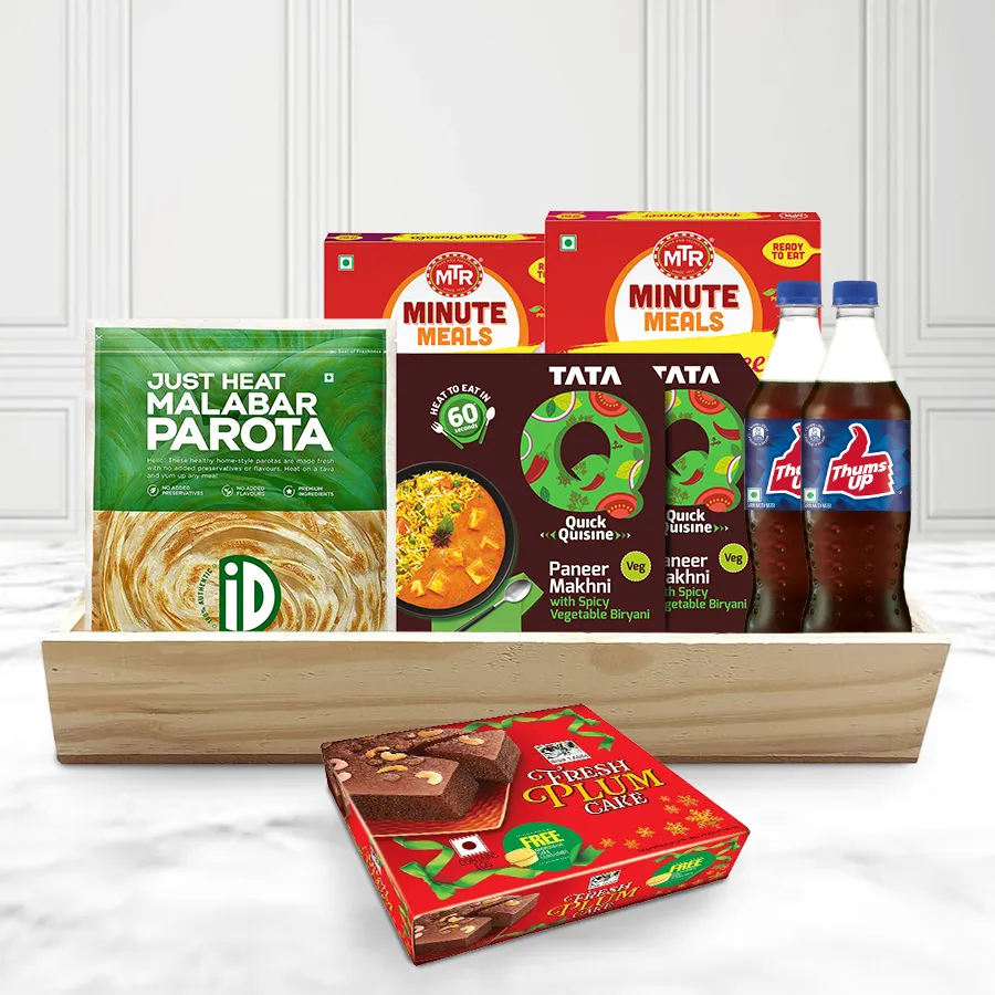 A festive veg lunch hamper featuring Malabar Parotas, Chana Masala, Palak Paneer, Spicy Veg Biryani, Thums Up drinks, a plum cake, and a wooden tray, arranged appealingly for Christmas.