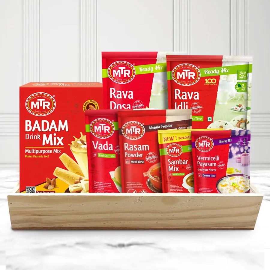 Finest MTR Mix Breakfast Hamper elegantly presented on a wooden tray, featuring Rava Dosa & Idli Mix, Vada Mix, Rasam & Sambar Powders, Vermicelli Payasam, and Badam Drink Mix.