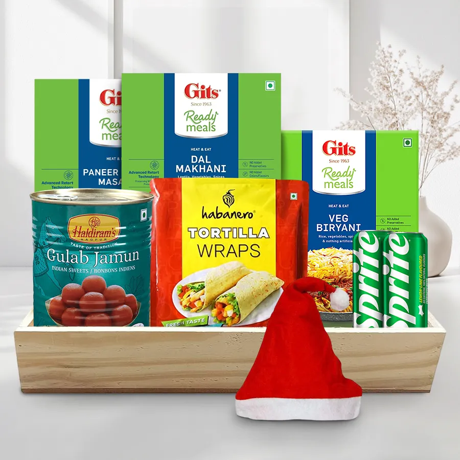 Finest Veg Selection Christmas Lunch Hamper with Habanero Tortilla Wraps, Gits Veg Biryani, Dal Makhani, Paneer Tikka Masala, Haldiram Gulab Jamun, Sprite cans, festive cap, and wooden tray.