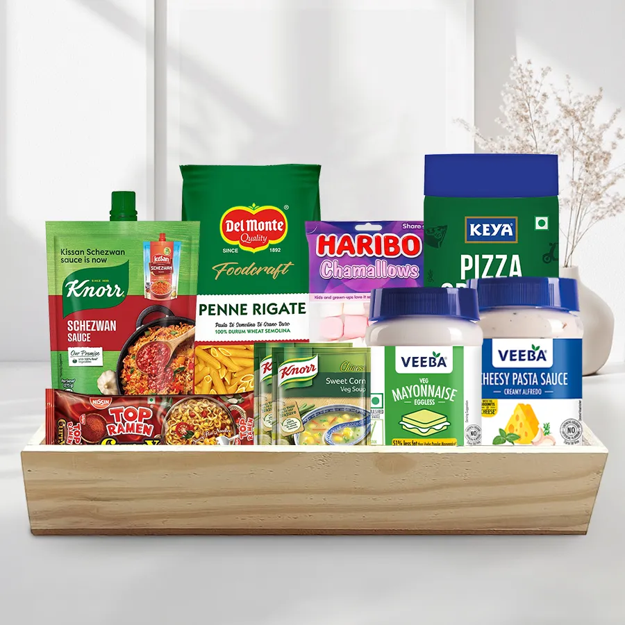 Sensational Selection Breakfast Basket featuring noodles, sauce, pasta, oregano, dressings, soup, marshmallows, and a wooden tray.