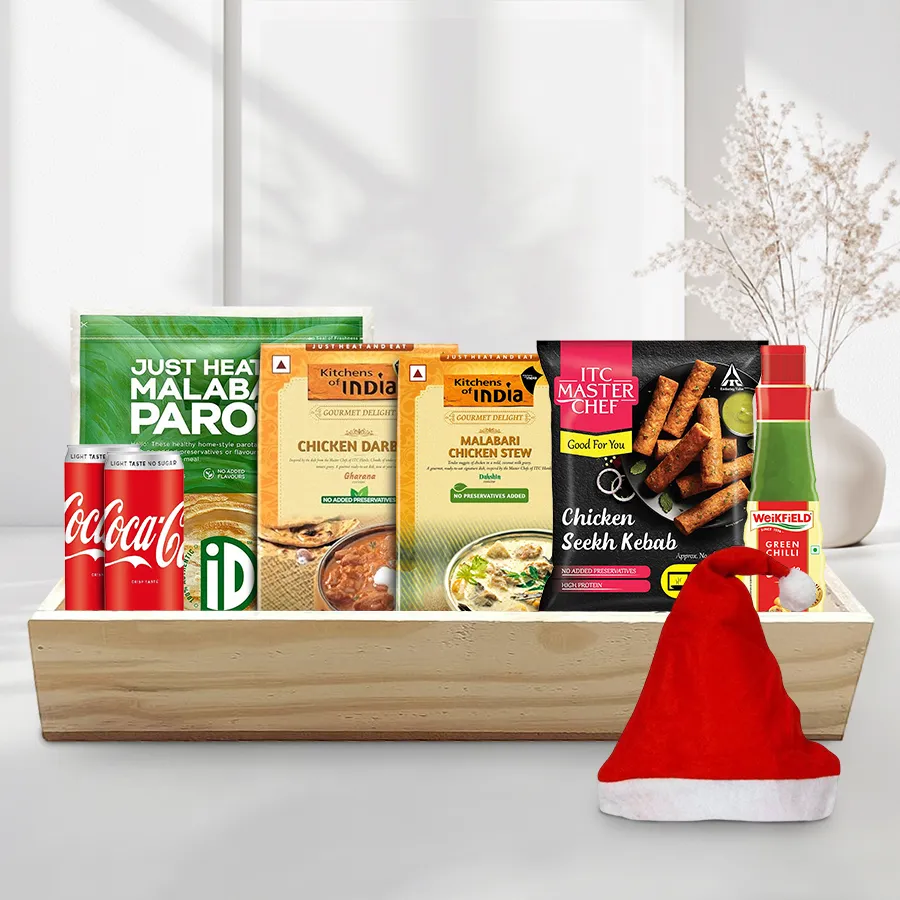 Lip Smacking Non Veg Lunch Hamper featuring Malabar Parotas, Chicken Darbari, Chicken Stew, Chicken Seekh Kebabs, Green Chilli Sauce, Diet Cokes, Merry Christmas cap, and wooden tray.