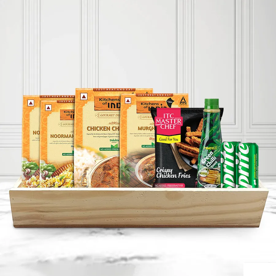 Classic Non-Veg Lunch Treat Hamper featuring biryani, chicken dishes, fries, sauce, and Sprite cans on a wooden tray.