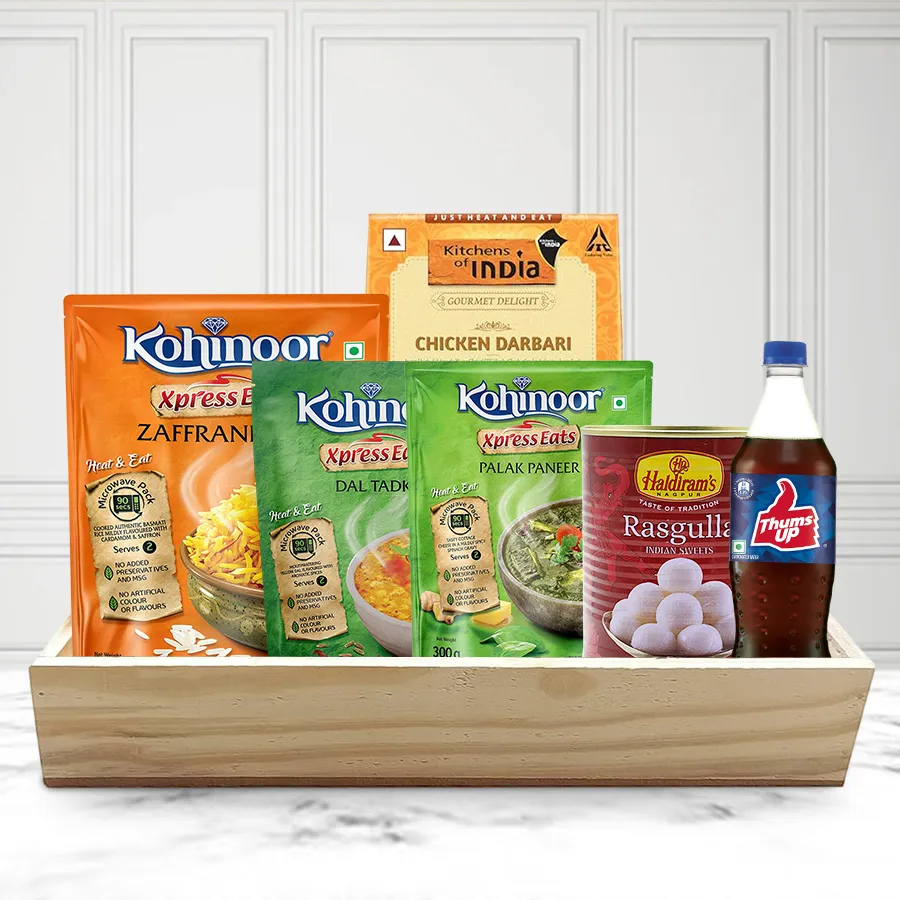 Special Non-Veg Lunch Hamper for Christmas featuring Kohinoor Zaffrani Rice, Dal Tadka, Palak Paneer, Chicken Darbari, Haldiram Rassogolla, and Thums Up on a wooden tray.