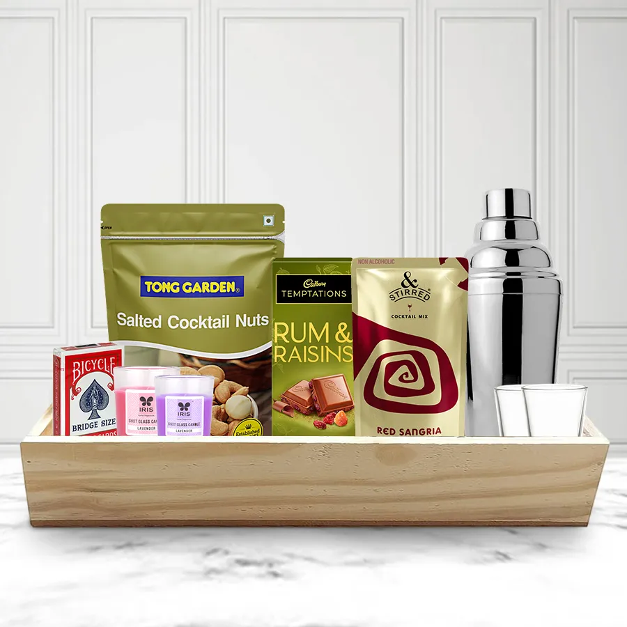 Superb Choice of Christmas Evening Snacks Hamper featuring shot glasses, cocktail shaker, red sangria mix, salted nuts, rum & raisins, playing cards, candles, and a wooden tray.
