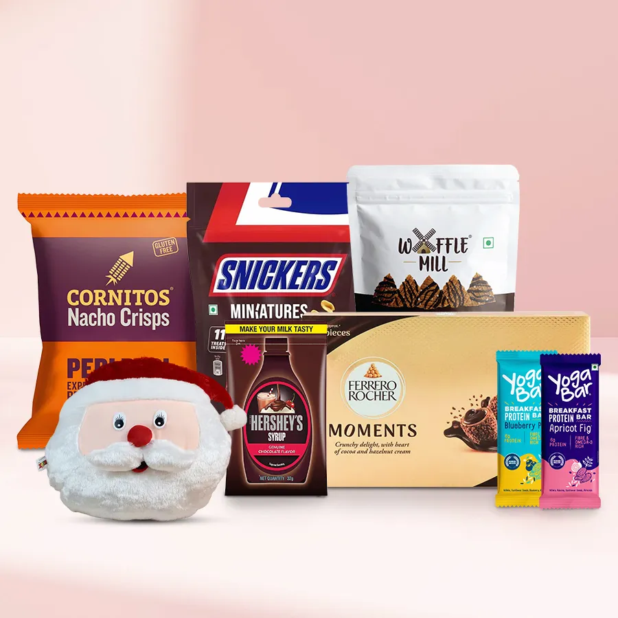 Magical Santa cushion surrounded by chocolates and festive treats