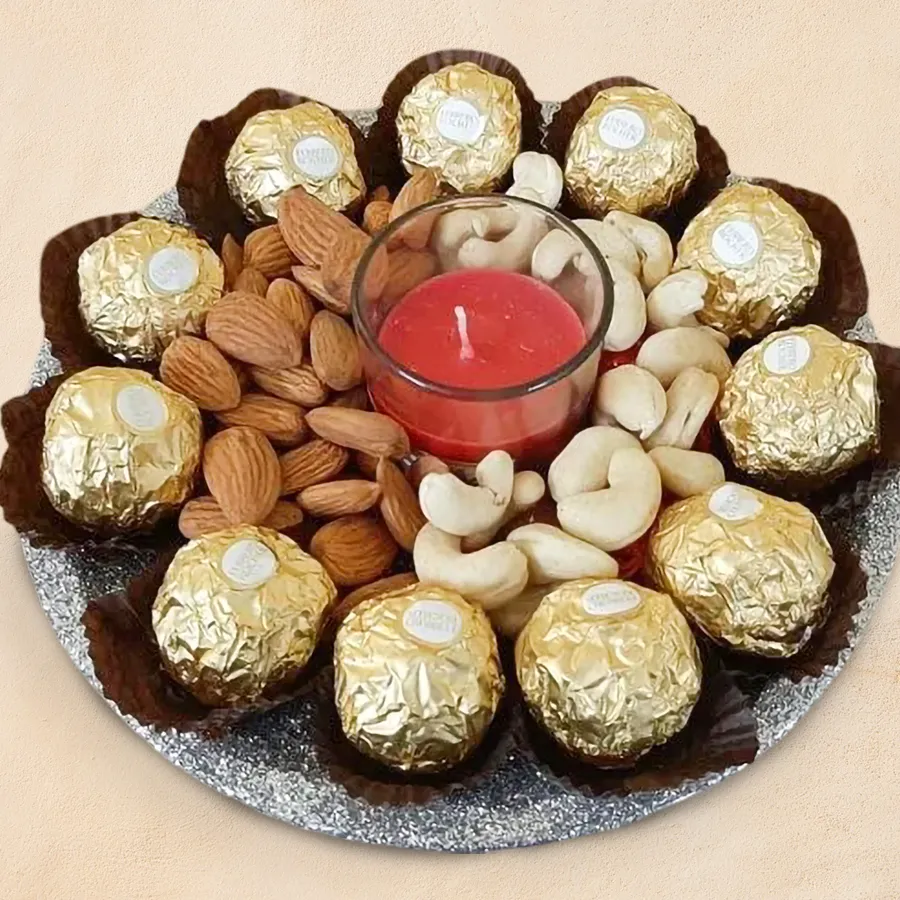 Charming gift hamper featuring Ferrero Rocher chocolates, dry fruits, aroma candles, and a decorative plate