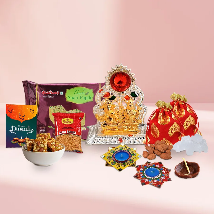 Diwali sweet and dry fruits hamper featuring Ganesh Lakshmi Mandap, almond and mishri potlis, Haldirams Soan Papdi and Bhujia, dry fruit chikkis, chocolate diya, mandala diyas, and a Diwali card in a decorative gift box