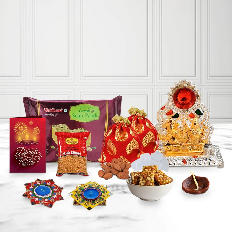 Indulging Sweets and Nut Treat Hamper for Diwali with Dot Mandala Diya, Ganesh Lakshmi Mandap, and Chocolate Diya, featuring Haldiram Bhujia, assorted almond and mishri potlis, dry fruit chikki, and Soan Papdi, elegantly presented in a gift box with a Diwali card.